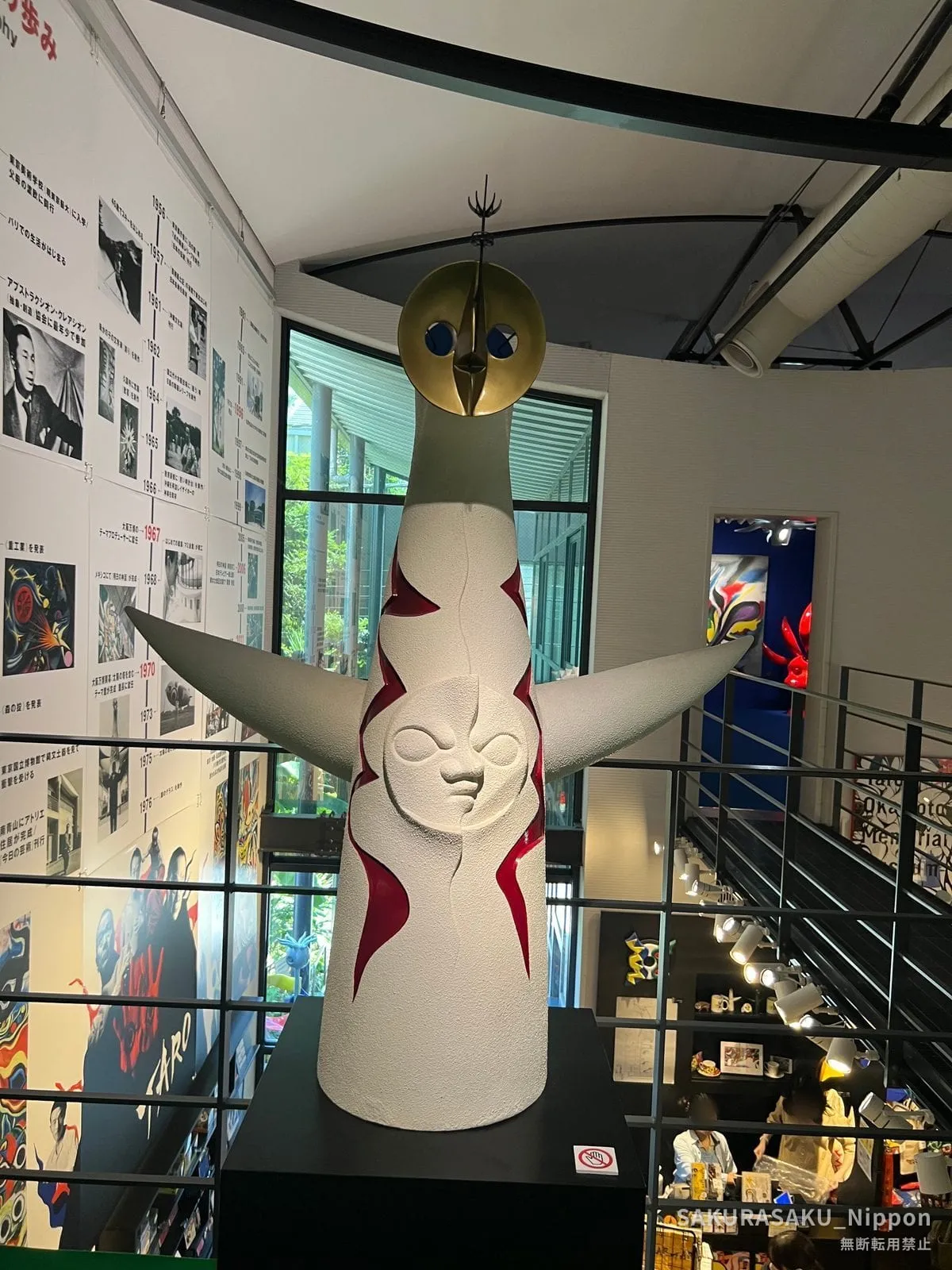 Model of the Tower of the Sun standing on a plinth inside the museum, with the shop below