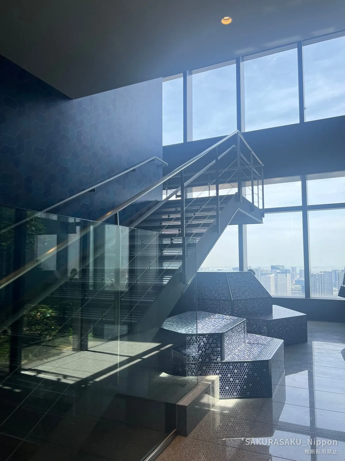 The free SKY VIEW space on the 46th floor, with its glass wall and mosaic seating