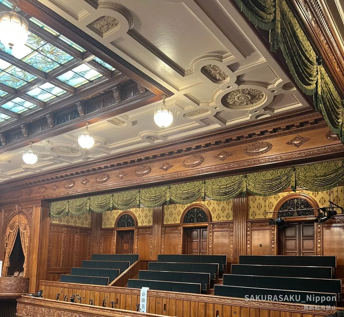 The upper wall and stained-glass ceiling of the chamber, with green draperies