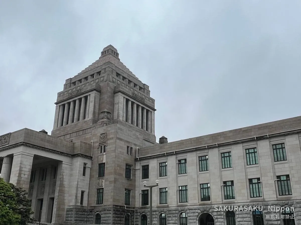 The National Diet Building seen from outside, its stepped central tower rising against a grey sky