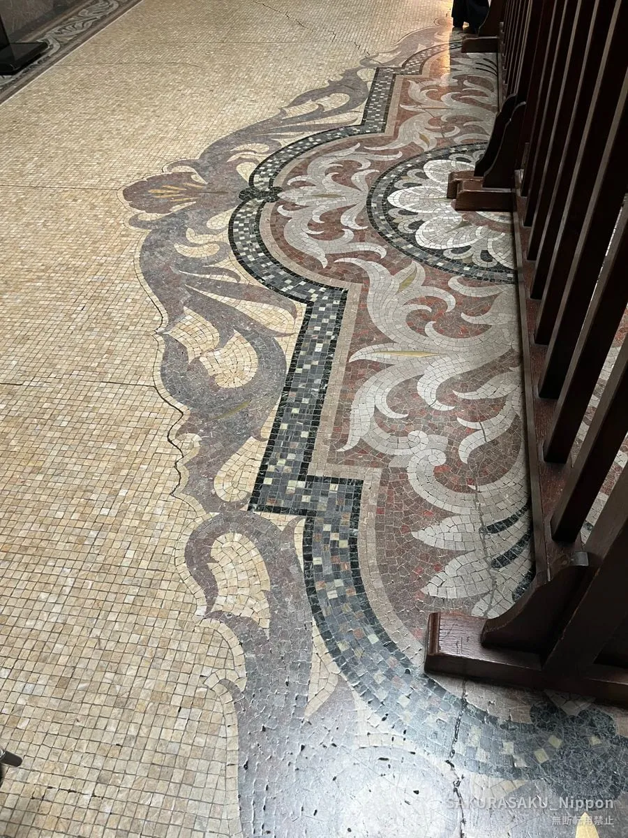 Mosaic floor of tiny stone tesserae in an arabesque pattern