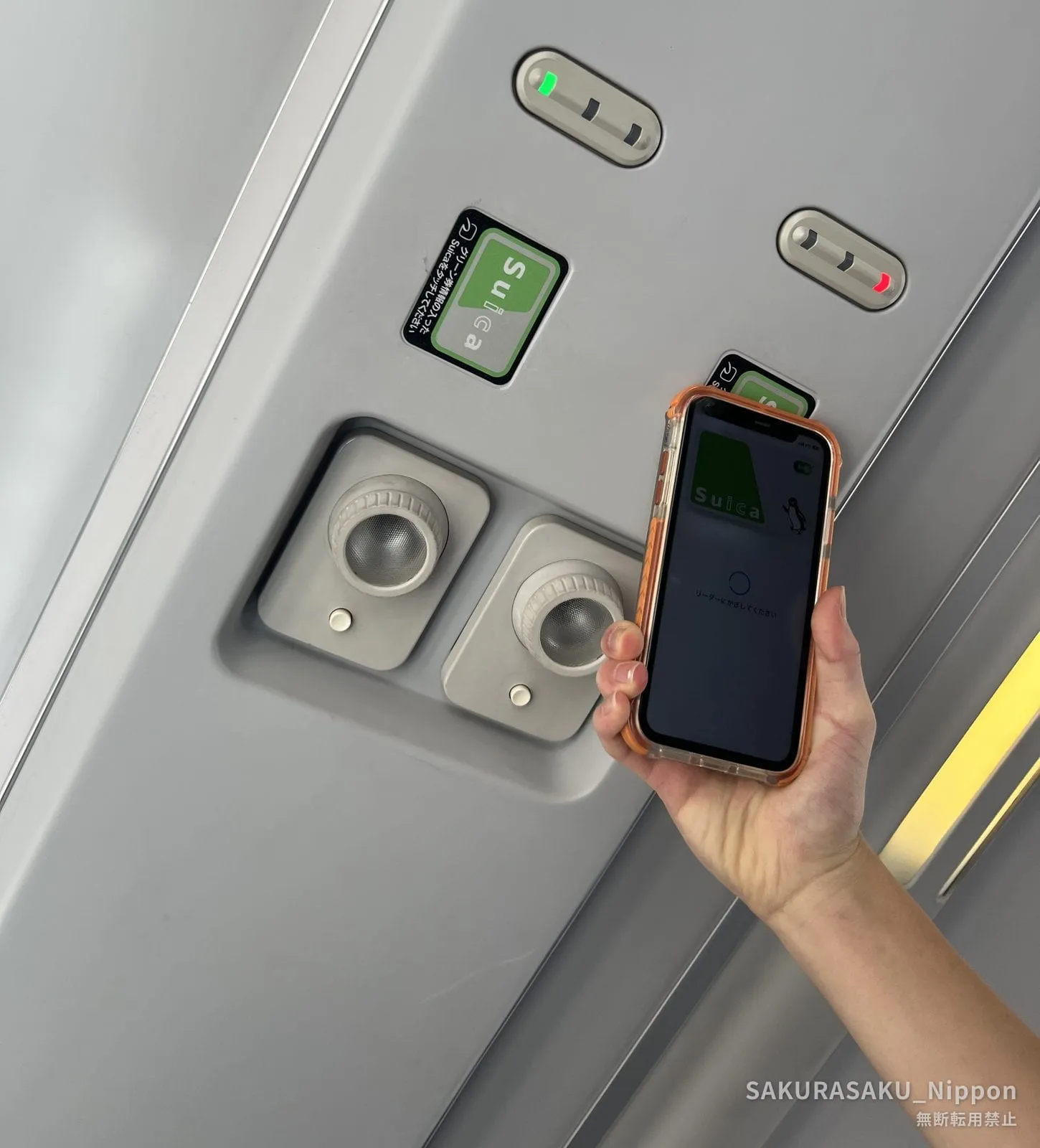 A phone being held up to the card reader in the ceiling above a Green Car seat
