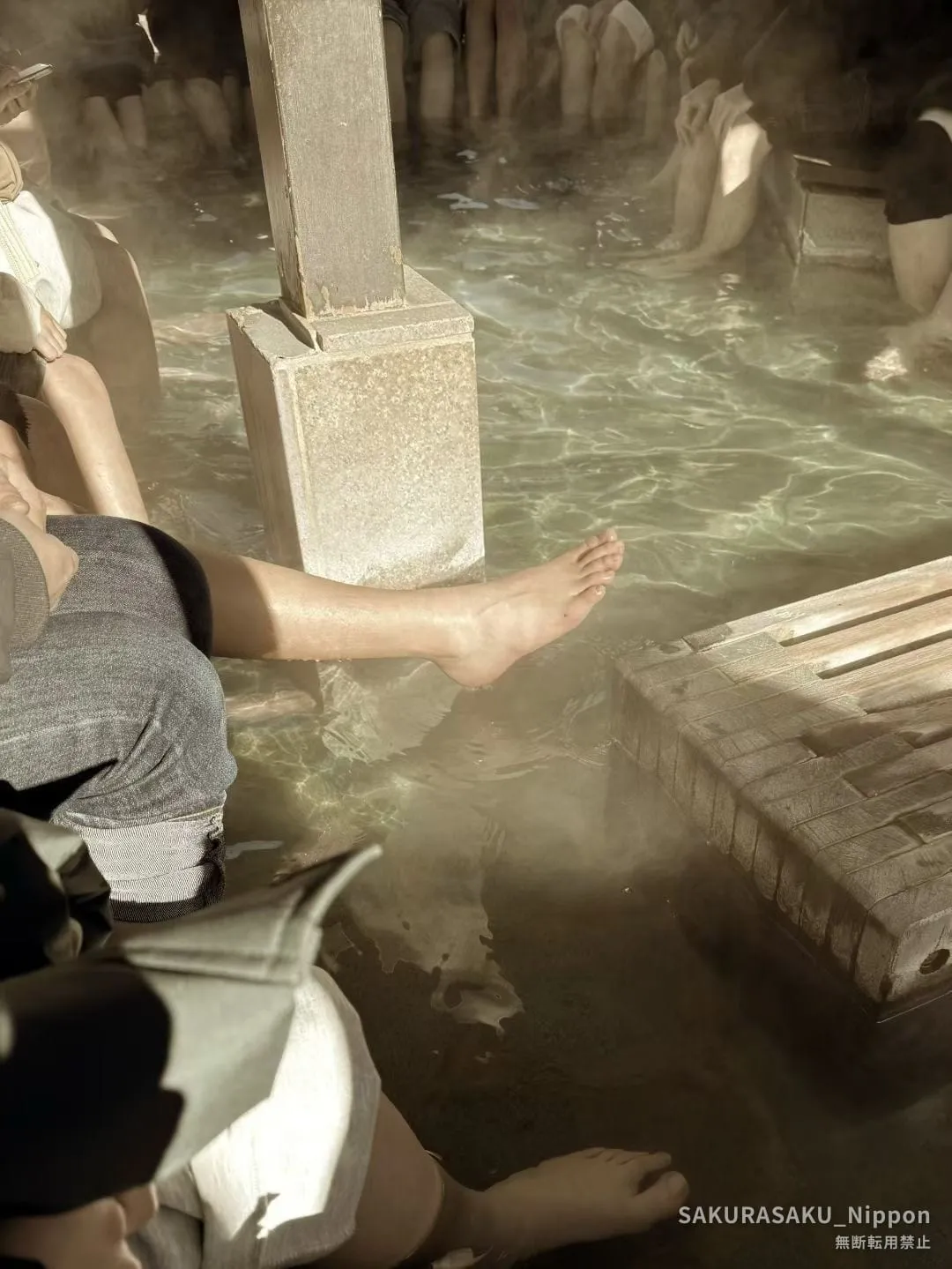 A public foot bath in Kusatsu, feet resting in the steaming water