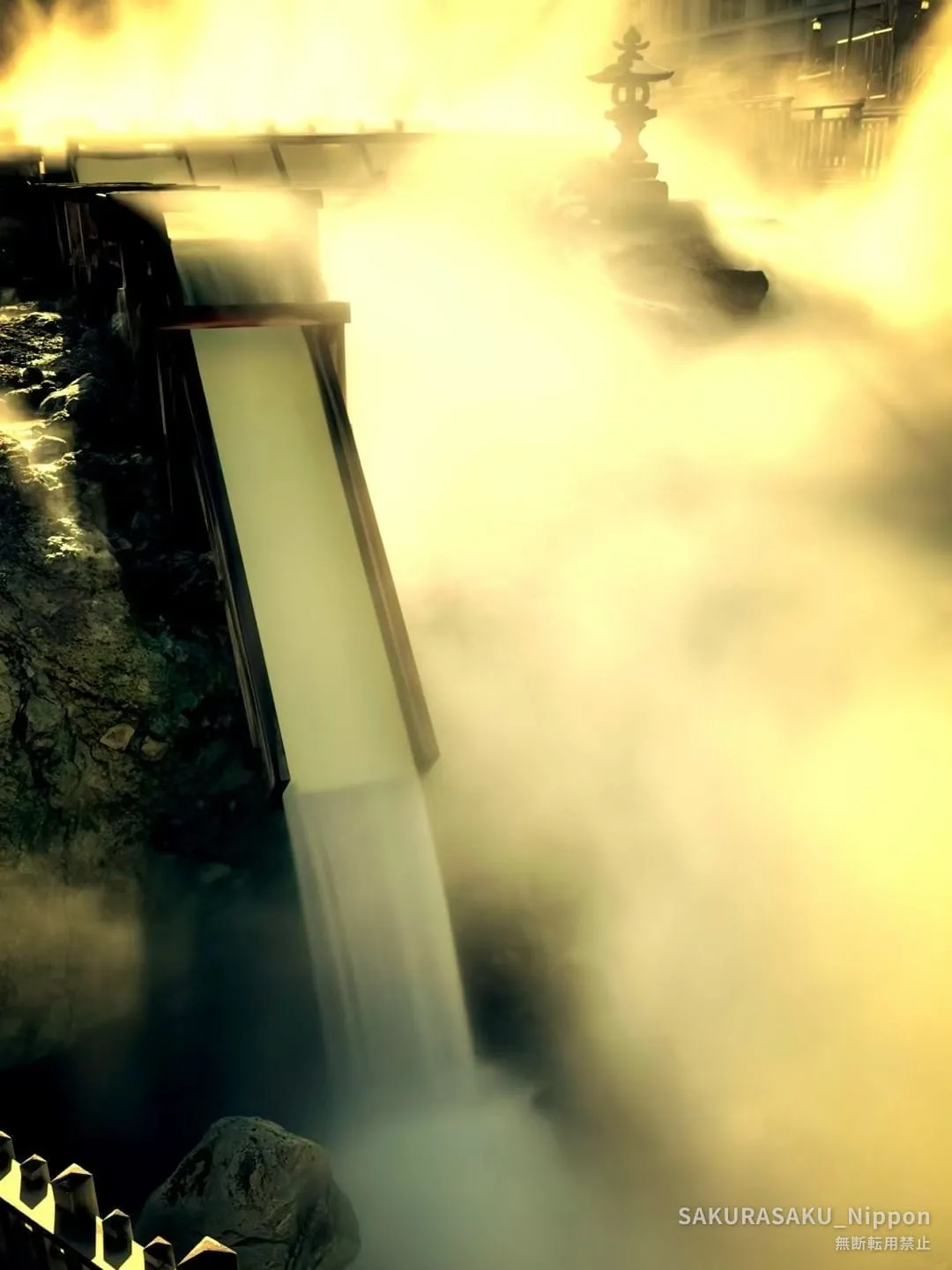 The hot-water falls of the yubatake glowing in the low winter sun
