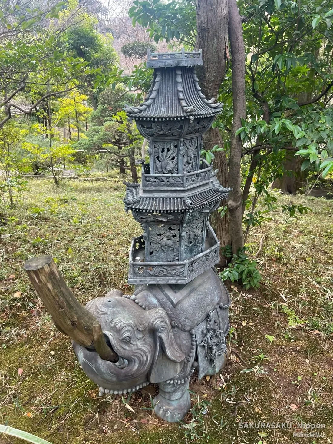 Stone lantern carved with elephants in the museum garden