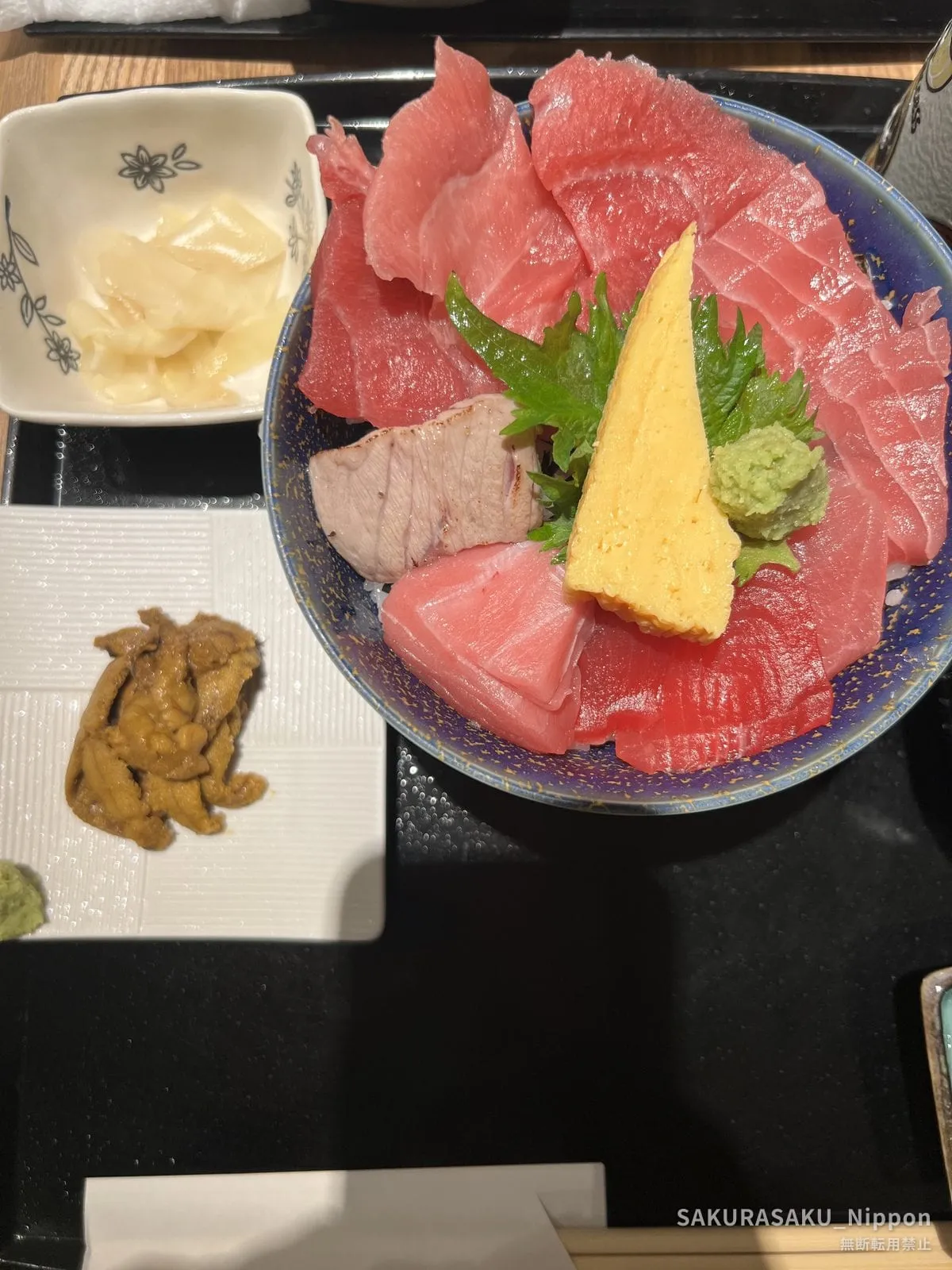 A tuna rice bowl at Toyosu Market — with the sea urchin served alongside, dark and bitter