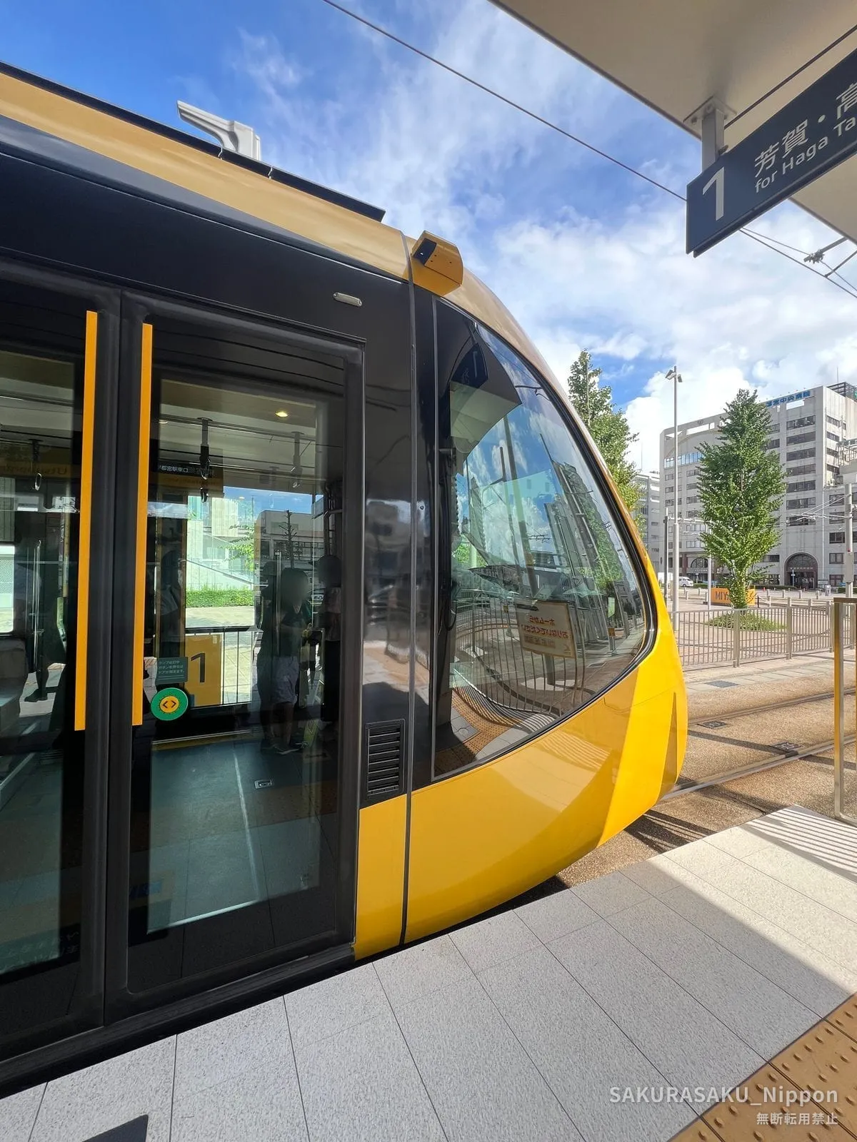 A yellow LIGHTLINE tram at the Utsunomiya Station east exit stop